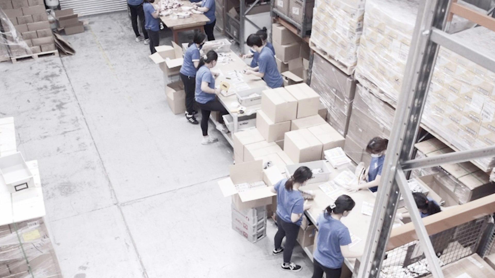 pick and pack team team working in a fulfilment warehouse facility